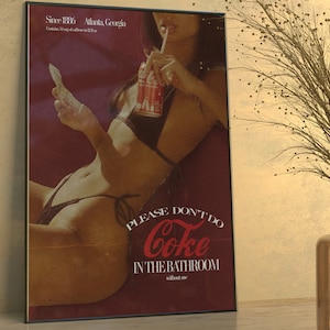 Brunette girl in a black bikini holding a red Coke can and playing cards. Text below reads "Please Don't Do Coke In The Bathroom" and "without me" is written in small text below it. Top right corner reads "Since 1886" "Atlanta, Georgia".