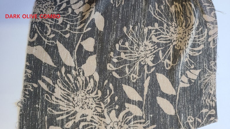 May include: Dark olive fabric with a beige floral print. The fabric has a textured, woven look.