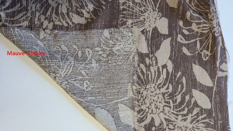 May include: Close-up of a brown fabric with a white floral pattern. The fabric has a textured surface and a frayed edge. The text "Mauve Combo" is visible in the lower left corner of the image.