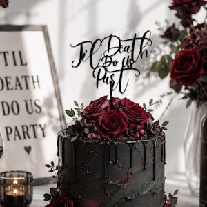 May include: A black wedding cake with dark red roses and a cake topper that reads "Til Death Do Us Part." The cake has a textured finish with dark drips. The overall theme is gothic and romantic.