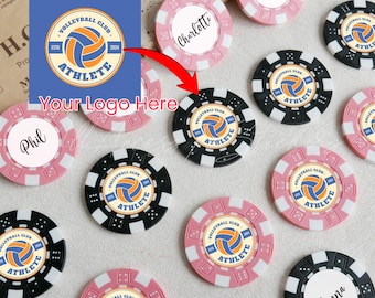 May include: A collection of round poker chips in black and pink, featuring custom designs with a volleyball graphic, the text Volleyball Club Athlete Est 2024, and individual names like Charlotte, Lauren, Phil, and Anna printed on the center.
