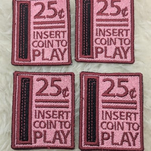 May include: Four pink and red embroidered patches with black stitching. Each patch reads "25¢ INSERT COIN TO PLAY".