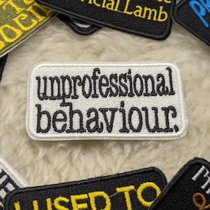 Puede incluir: Parche blanco bordado con texto negro que dice "unprofessional behaviour".