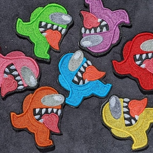 May include: Seven embroidered patches featuring characters from the popular video game Among Us. The patches are in various colors, including green, pink, blue, red, and yellow. Each patch features a different character with a unique expression.