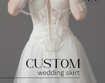 May include: A white wedding skirt with a lace bodice and the text "CUSTOM wedding skirt".