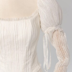 a woman's white dress on a mannequin head