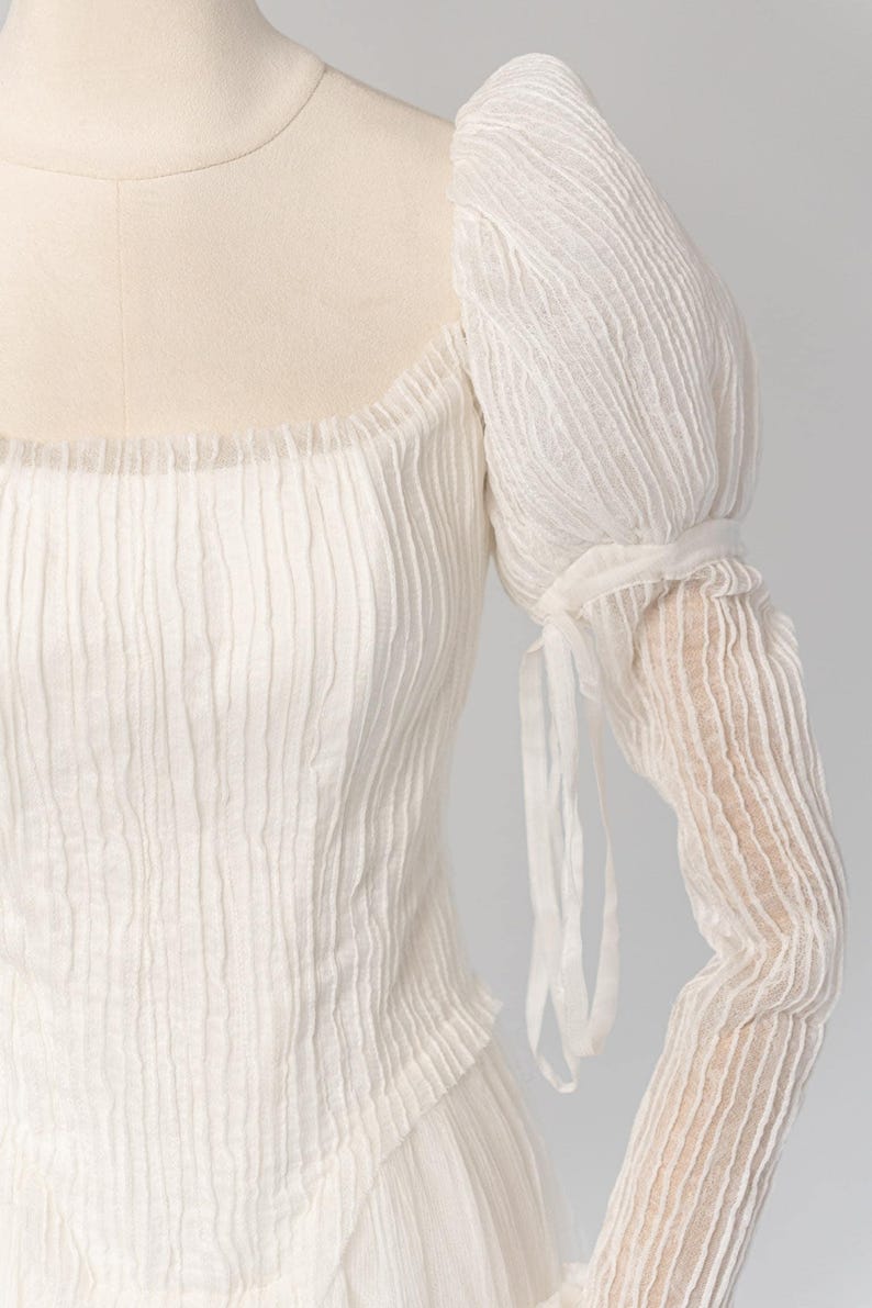 a woman's white dress on a mannequin head