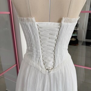 a white dress on a mannequin in a room
