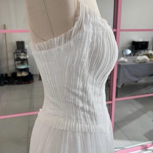 a white dress on a mannequin in a room
