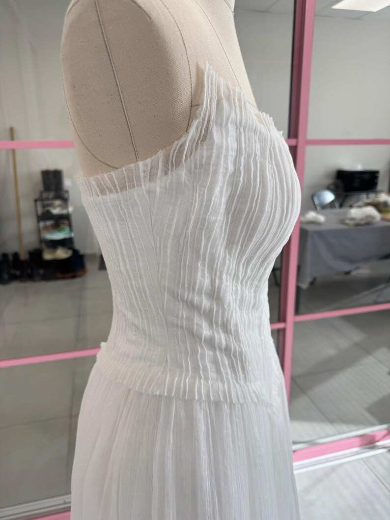 a white dress on a mannequin in a room