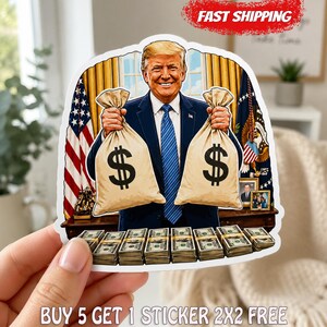 May include: A die-cut sticker featuring a cartoon illustration of a man in a navy blue suit and blue tie standing behind a desk. He holds two large beige money bags with black dollar signs. Stacks of green paper currency are arranged on the desk.
