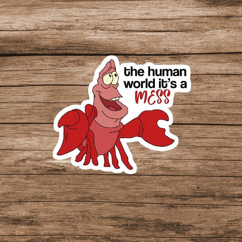 Pode incluir: Um adesivo recortado apresentando um caranguejo vermelho com garras grandes e uma express&atilde;o sorridente. Ao lado do personagem, o texto diz: the human world it's a MESS, com a palavra MESS impressa em fonte vermelha negrito sobre fundo branco.