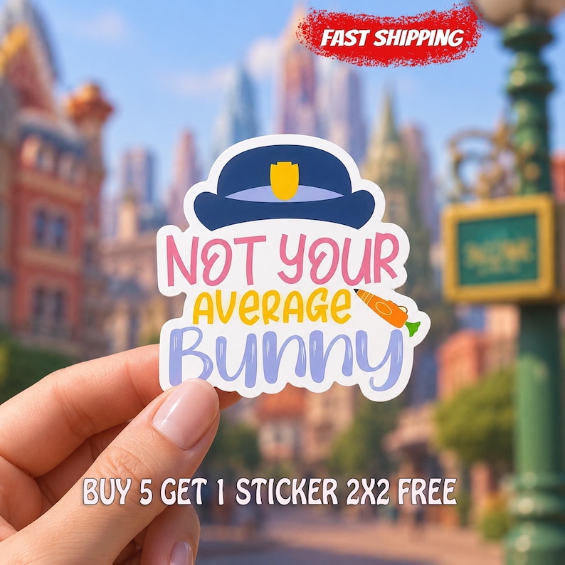 May include: A die-cut sticker featuring a dark blue police hat with a gold badge at the top. Below the hat, the text reads NOT YOUR AVERAGE BUNNY in pink, yellow, and light purple. A small orange carrot graphic is positioned next to the word AVERAGE.