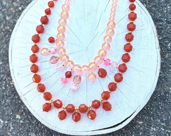 Beaded charm necklaces with handcrafted charms using carnelian, glass, rose quartz and hematite