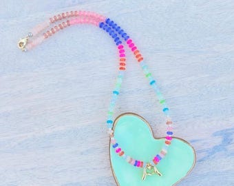 Beaded rondelle necklace with heart hands charm.