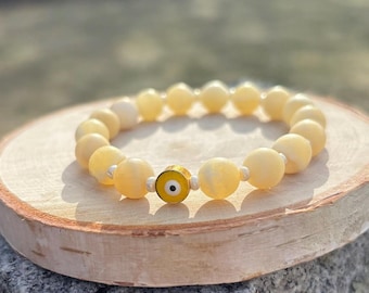 Mental health awareness bracelet with yellow evil eye and citrine gemstone beads.