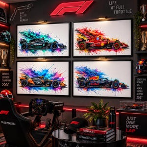 May include: Four framed wall art prints featuring Formula 1 race cars in vibrant watercolour splash styles. The top left shows a Mercedes, top right a Ferrari, bottom left a McLaren, and bottom right a Red Bull. Each print displays detailed racing liveries.