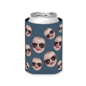 May include: A blue can cooler with a repeating pattern of baby faces wearing sunglasses.