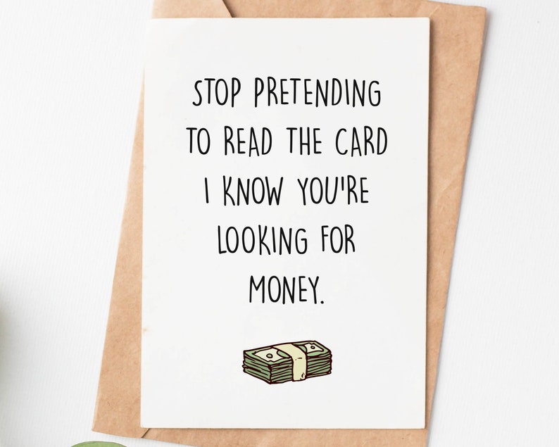 May include: A white card with black text that reads "Stop pretending to read the card I know you're looking for money." A cartoon drawing of a stack of money is below the text.