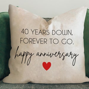 May include: A white throw pillow with the text "40 YEARS DOWN, FOREVER TO GO. happy anniversary" in black script font. A red heart is centered below the text.