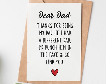May include: A white card with black text that reads "Dear Dad, THANKS FOR BEING MY DAD. IF I HAD A DIFFERENT DAD, I'D PUNCH HIM IN THE FACE & GO FIND YOU." A red heart is at the bottom of the card.