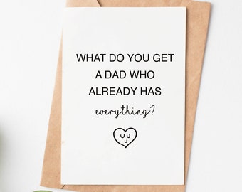May include: A white card with black text that reads "What do you get a dad who already has everything?" with a small heart with a face drawn inside.