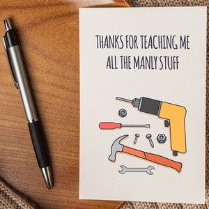 May include: A card with a hand-drawn illustration of tools, including a drill, hammer, wrench, and nails. The text on the card reads "Thanks for teaching me all the manly stuff."