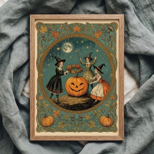 May include: A framed rectangular art print featuring three figures in pointed hats surrounding a large jack-o'-lantern. The scene is set against a dark teal background with a full moon, stars, and an ornate border of autumn leaves and thistles.