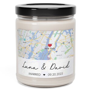 May include: A white candle jar with a black lid. The label features a map of New York City with a red heart over the city. The text "Luna & David" is written in cursive script below the map. The text "MARRIED" and a heart symbol are above the date "09.20.2023".