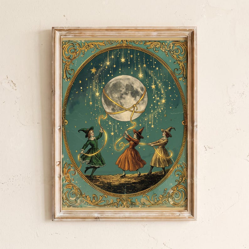May include: A framed rectangular wall art print featuring three figures in pointed hats and dresses holding golden ribbons connected to a large moon. The scene is set against a dark teal background with falling stars and ornate gold filigree borders.