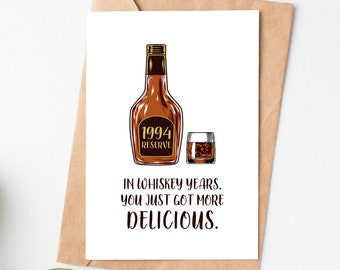 May include: A white card with a brown bottle and a glass of whiskey. The bottle has a gold label that says "1994 Reserve". The text on the card reads "In whiskey years, you just got more delicious."