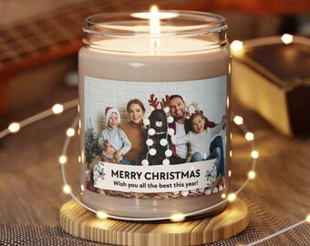 May include: A brown glass candle with a white label. The label has a photo of a family with a dog wearing reindeer antlers. The text on the label reads "Merry Christmas Wish you all the best this year!"