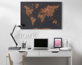 May include: A white desk with two drawers and a black laptop computer on top. A white chair with wooden legs is in front of the desk. A world map with a dark gray background and brown continents is hanging on the wall above the desk. The word "HOME" is spelled out in white letters on the wall below the map.