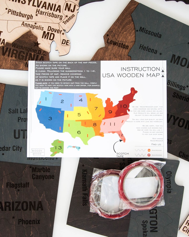 May include: A close-up of a USA wooden map puzzle with instructions on how to assemble it. The map is divided into 14 pieces, each with a number on it. The instructions include a diagram showing the correct placement of each piece. The map is made of wood and has a natural finish. The instructions are printed on a white sheet of paper.
