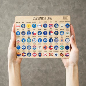 May include: A wooden board with a grid of 50 small circles, each containing a different state flag of the United States. The board is labelled "USA States Flags" and "Woody Wood".