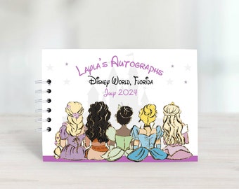 Puede incluir: Un libro de autógrafos blanco con un borde morado y un diseño de castillo. El libro tiene una encuadernación en espiral y presenta un grupo de princesas con el pelo largo. El texto de la portada dice "Layla's Autographs", "Disney World, Florida", y "July 2024".