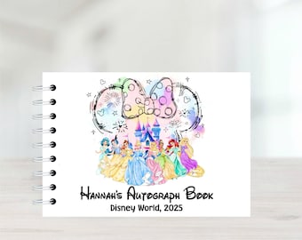 Puede incluir: Libro de autógrafos encuadernado en espiral blanco con un diseño de acuarela colorido. La portada presenta un lazo de Minnie Mouse, princesas de Disney y un castillo. El texto dice "Hannah's Autograph Book Disney World, 2025."