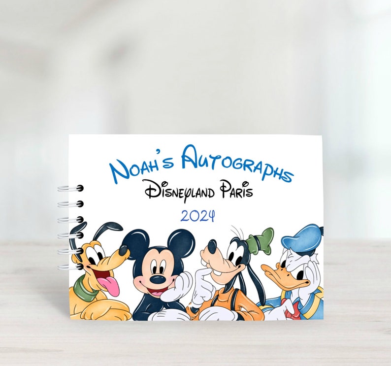 Design - Mickey & Friends :
A5 autograph book with protective covers.
20 blank white pages, suitable for use with sharpie. ring binder to side and personalised with wording of your choice.