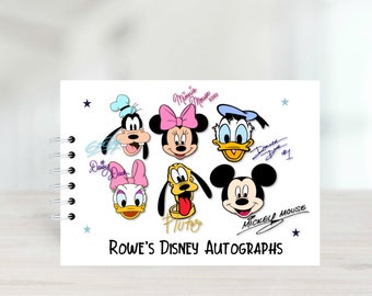 May include: A white spiral bound autograph book with a white background and colorful cartoon images of Mickey Mouse, Minnie Mouse, Donald Duck, Goofy, Pluto and Daisy Duck. The book has the text "Rowe's Disney Autographs" at the bottom.