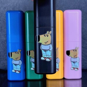 May include: A collection of colorful, rectangular containers. The containers are blue, green, black, yellow, and pink. Each container has a cartoon dog illustration on it. The dog is wearing a sweater and jeans.