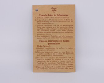 vintage mattress plastic patches, antique package with patches, retro packaging with tools, old cycling supply, repair kit