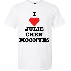 May include: White t-shirt with the text "I ♥ Julie Chen Moonves" in black font, with a red heart replacing the word "love". The shirt is a short-sleeved crew neck.