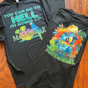 May include: Two black t-shirts with different designs. The first shirt has the text "You can go to Hell I'm going to Margaritaville" with a parrot and palm trees. The second shirt has a parrot wearing sunglasses and a hat with the text "It's 5 O'Clock Somewhere".