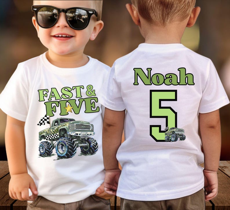 Pictured is a boy wearing a white t-shirt with a green and black monster truck graphic. The front of the shirt says "FAST & FIVE" in green lettering. The back of the shirt has the name "Noah" and the number "5" in green and a small version of the camo truck