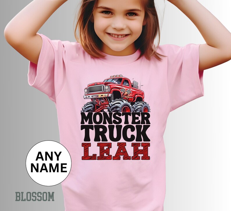 May include: Pink t-shirt with a monster truck graphic and the text "Monster Truck Leah".