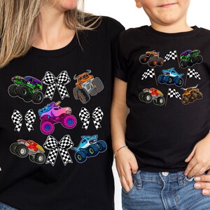 mother and son wearing matching mommy and me shirts in black with monster trucks and checkered race bows on the moms shirt and checkered racing flags on the boy's shirt. Race Day, Birthday Party, Boy Mama gift set outfit for mother and son.