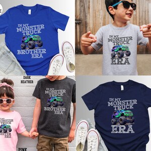 May include: A selection of children's t-shirts in shades of blue, grey, pink, and navy. Each shirt displays a monster truck graphic with the text "IN MY MONSTER TRUCK" and "ERA". Some shirts also feature "BROTHER" or "SISTER".