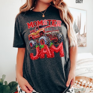 May include: Dark heather grey t-shirt with a graphic of a monster truck with the words "Momster Jam" in red and white letters.
