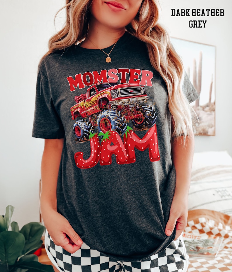 May include: Dark heather grey t-shirt with a graphic of a monster truck with the words "Momster Jam" in red and white letters.