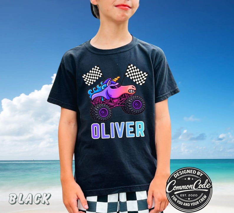 May include: Black t-shirt featuring a colorful graphic of a unicorn monster truck with the name "OLIVER" in a gradient font. The design includes checkered flags and the text "DESIGNED BY COMMON CODE EST. 2020 FOR YOU AND YOUR CREW."